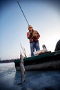 Winter season- Fisherman catch pike on the river