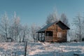 Winter season, landscape picture of a holiday house covered by snow at sunset, country landscape with timber fence Royalty Free Stock Photo