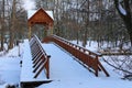 Winter season in the Pushcha-Vodytsia. Picturesque landscape view of old wooden bridge over the frozen lake. Royalty Free Stock Photo