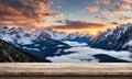 Winter serenity: Empty wooden table with snowy mountain backdrop