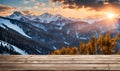 Winter serenity: Empty wooden table with snowy mountain backdrop