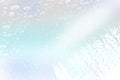 Winter shiny snowflakes blurred background in light blue colors