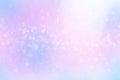 Winter shiny snowflakes blurred background in light blue pink colors