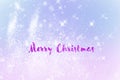 Winter shiny snowflakes blurred background in light blue pink colors.Inscription Merry Christmas