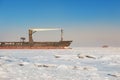 Winter shipping. Big cargo ship in frozen ice sea Royalty Free Stock Photo