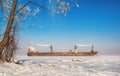 Winter shipping. Big cargo ship in frozen ice sea Royalty Free Stock Photo
