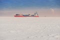 Winter shipping. Big cargo ship in frozen sea fairway Royalty Free Stock Photo