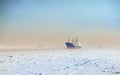 Winter shipping. Big cargo ship in ice sea fairway