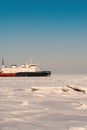 Winter shipping. Big cargo ship in ice sea fairway