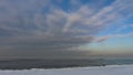 Winter shoreline of baltic sea with snow and ice under blue sky with clouds, selective focus