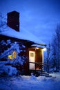 Winter shot of house in northern Sweden with snow and strong blue and yellow colors Royalty Free Stock Photo