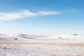 Winter Siberian landscape. Snowy hills and lonely trees