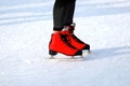 Winter skating rink. Red skates skate on the ice. Active family sport during the winter holidays and cold season Royalty Free Stock Photo