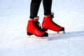 Winter skating rink. Red skates skate on the ice. Active family sport during the winter holidays and cold season Royalty Free Stock Photo