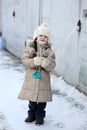 Winter small girl with long hair holds big icicle Royalty Free Stock Photo