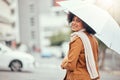 Winter, smile and woman with an umbrella for the rain while walking in the city of Portugal. Street, happy and young
