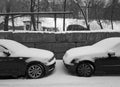 Winter, snow, cityscape, two cars. Black and white photography.