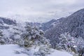 Winter snow-covered forest in the mountains. Shining background bokeh. Mountain peaks covered with snow in winter Royalty Free Stock Photo