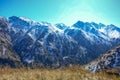 Winter snow covered mountain peaks against blue sky. Kyrgyzstan Royalty Free Stock Photo