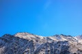 Winter snow covered mountain peaks against blue sky. Kyrgyzstan Royalty Free Stock Photo