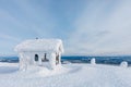 Winter snow covered wood hut. Frozen log cabin in Finland