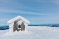 Winter snow covered wood hut. Frozen log cabin in Finland Royalty Free Stock Photo