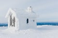 Winter snow covered wood hut. Frozen log cabin in Finland Royalty Free Stock Photo