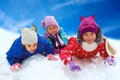 Winter snow, happy children sledding at winter time Royalty Free Stock Photo