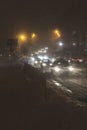 Winter snow storm. Traffic jam at night. Car blurred at the street. Royalty Free Stock Photo