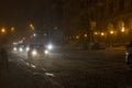 Winter snow storm. Traffic jam at night. Car blurred at the street. Royalty Free Stock Photo