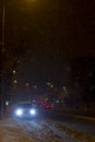 Winter snow storm. Traffic jam at night. Car blurred at the street. Royalty Free Stock Photo