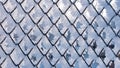 Winter snow texture made of metal mesh covered with snow hoarfrost. Frozen fence Royalty Free Stock Photo