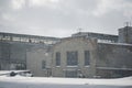 Winter, snowfall. Photo of the old factory. windows and roof of the old factory building. snow-covered old factory Royalty Free Stock Photo