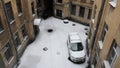 Winter snowfall in the yard with a parked car aerial view
