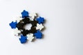 winter snowflake made of meeples - components of strategy board game on white background with copyspace. Game playing with friends