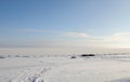 Winter snowy coastal landscape on a sunny day. Frozen river. Clear sky. Open space. Two boats on the shore