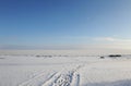 Winter snowy coastal landscape on a sunny day. Frozen river. Clear sky. Open space. Two boats on the shore