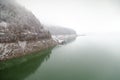 Winter snowy day in Bicaz Lake side at Mount Izvorul Dam, located in Piatra Neant, Romania Royalty Free Stock Photo