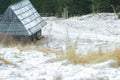 Winter snowy landscape with traditional log cabin and shake roof in forest