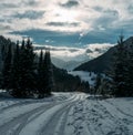 Winter snowy landscape view of a countryroad leading through spruce mountain forest in Slovakian Low Tatry mountains Royalty Free Stock Photo