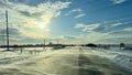 Winter. Snowy road. Gusts of wind. Sun. Towers with wires Royalty Free Stock Photo