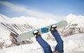 Winter sport concept with man on top of mountain ready to go down. legs on a snowboard in the background of the sky. Royalty Free Stock Photo