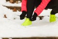 Woman tying sport shoes during winter Royalty Free Stock Photo