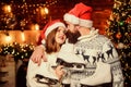 Winter sports. Happy couple with figure skates. Cheerful people with skates. Family leisure. Bearded man and Santa girl
