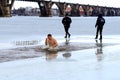 Winter sports, swimming, hardening. People bathe in the river under the supervision of lifeguards in uniform. Orthodox holiday