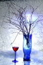 Still life. A winter bouquet. The blue vase. A glass of wine. Snow. Cold. Royalty Free Stock Photo