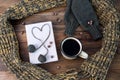 Winter still life with coffee, scarf and book on a wooden table Royalty Free Stock Photo