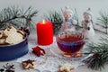 Winter still life: a cup of tea, Christmas gingerbread in a box against the background of a candle and figurines of snowmen, a Royalty Free Stock Photo