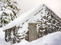 Stone cabin buried under ice and snow in winter Royalty Free Stock Photo