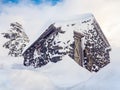 Stone cabin buried under ice and snow in winter Royalty Free Stock Photo